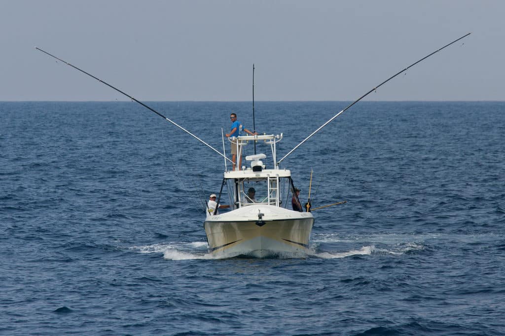 Small fishing boat outriggers and downriggers deployed